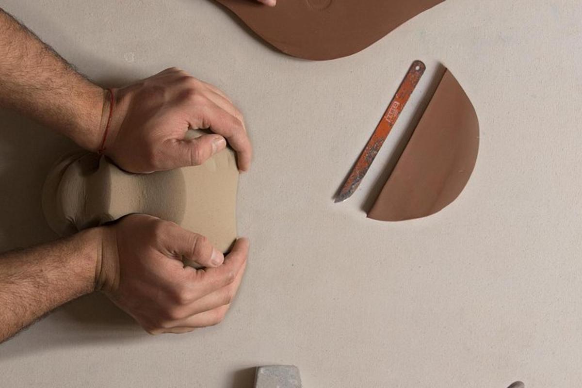 a person cutting a piece of paper with a knife