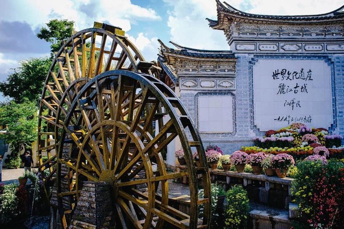 a wooden wheel in front of a building with flowers