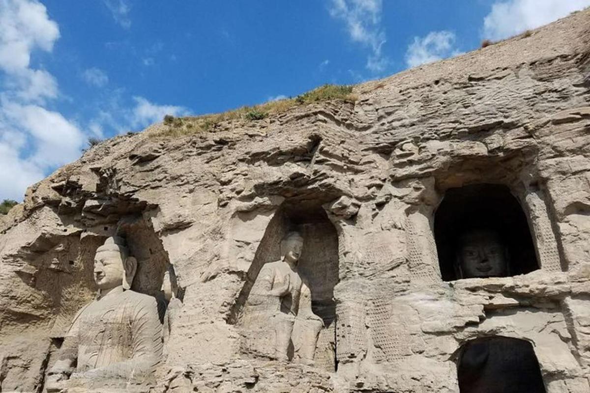 a stone building with statues on the side of it