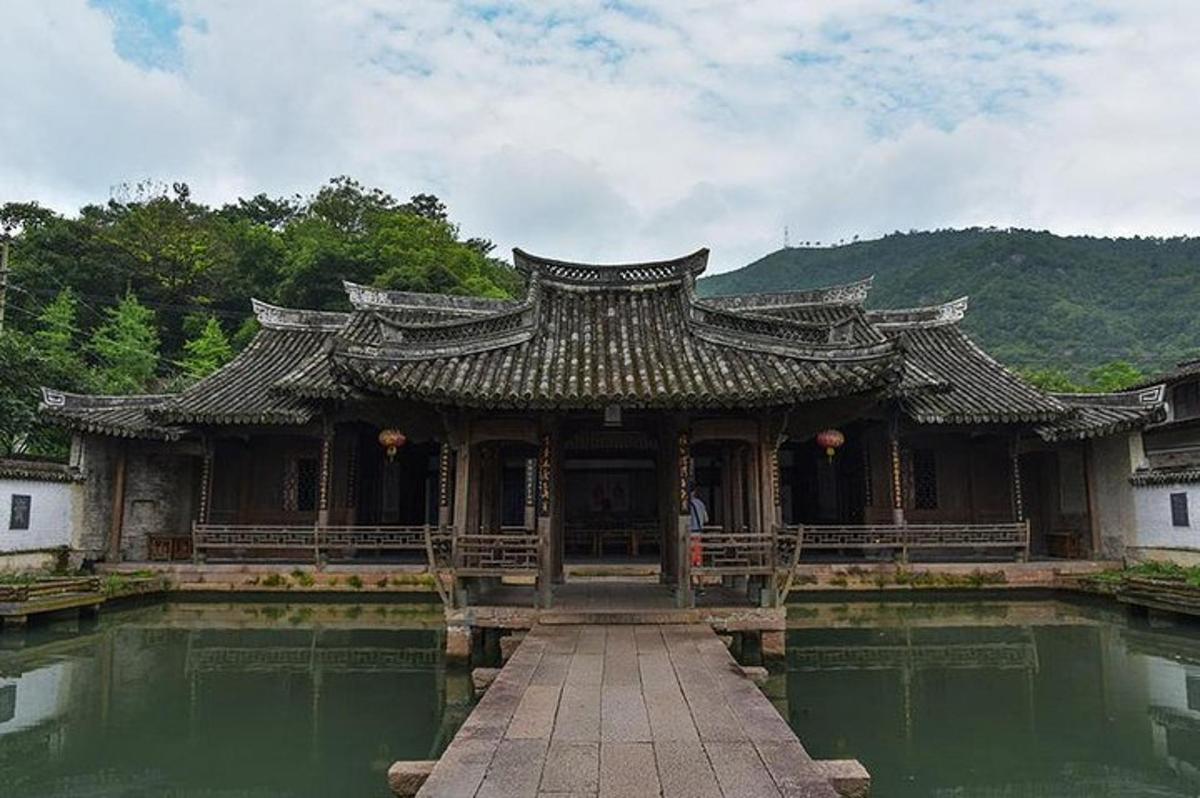 an asian style building with a pool of water