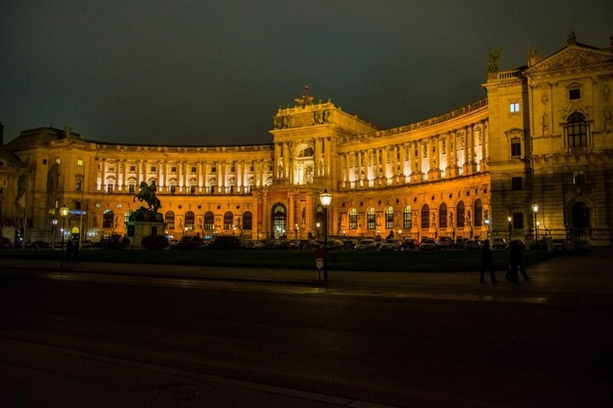 a large building with a statue in front of it at night