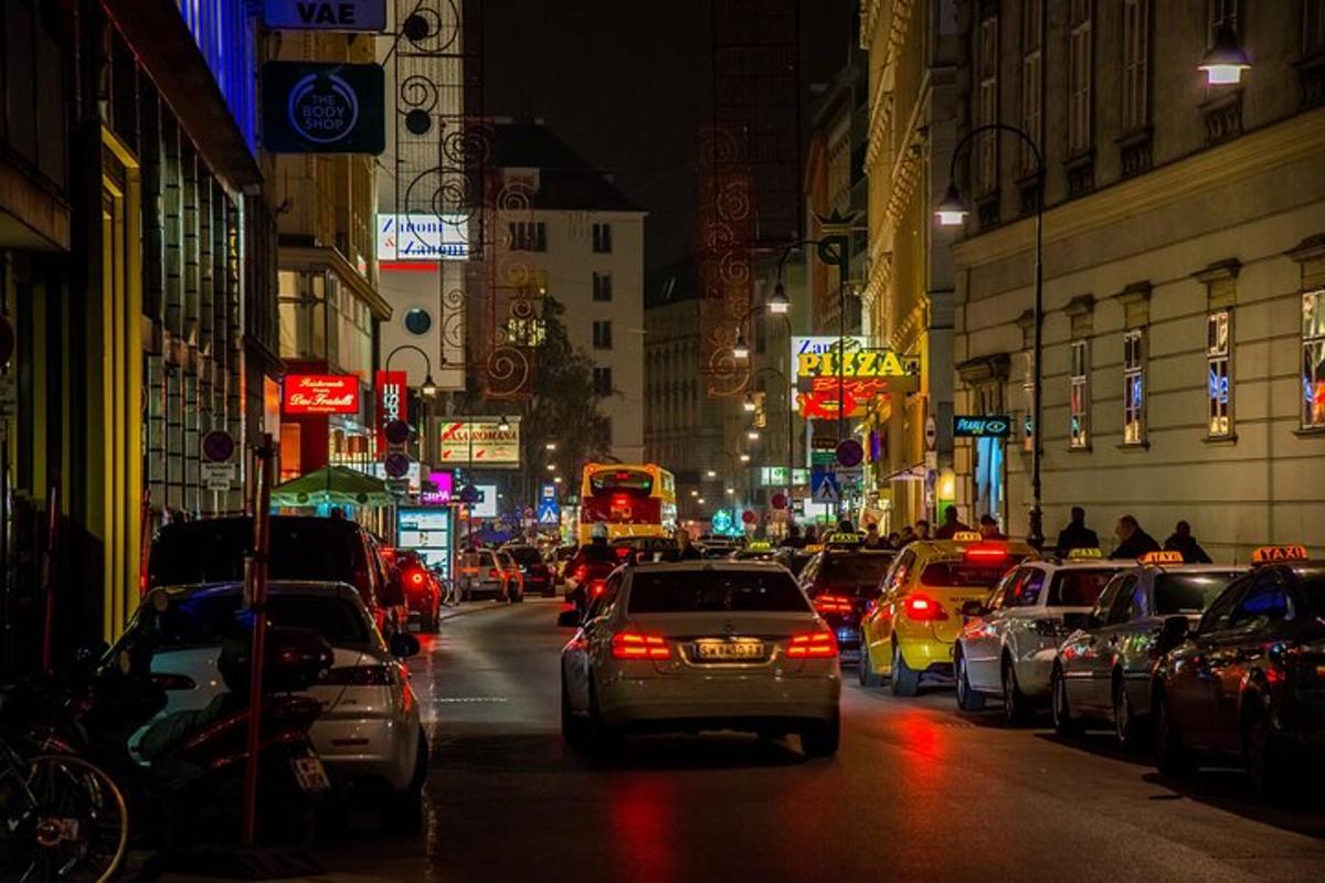 a busy city street at night with lots of cars