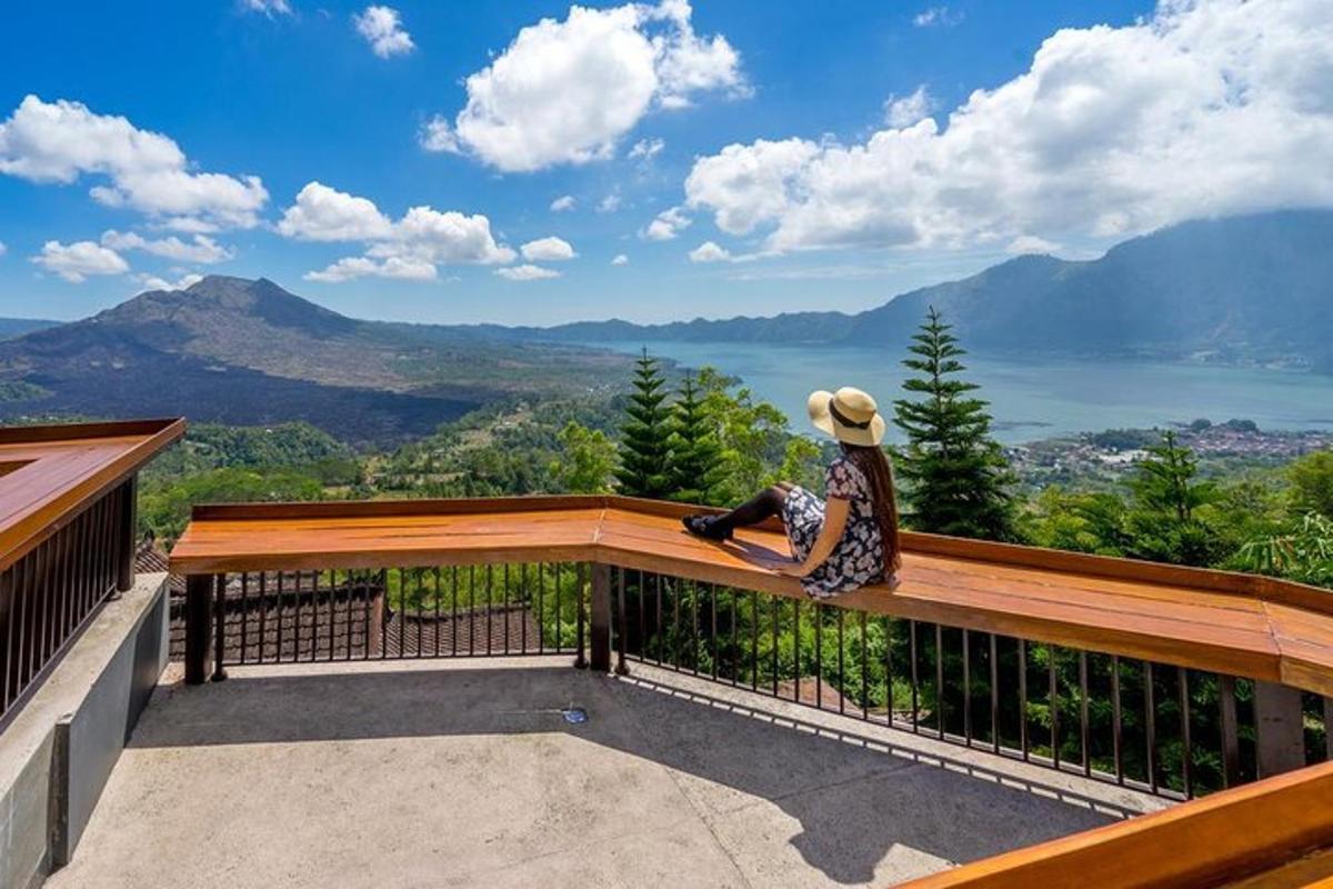 a person sitting on a balcony looking out at the mountains