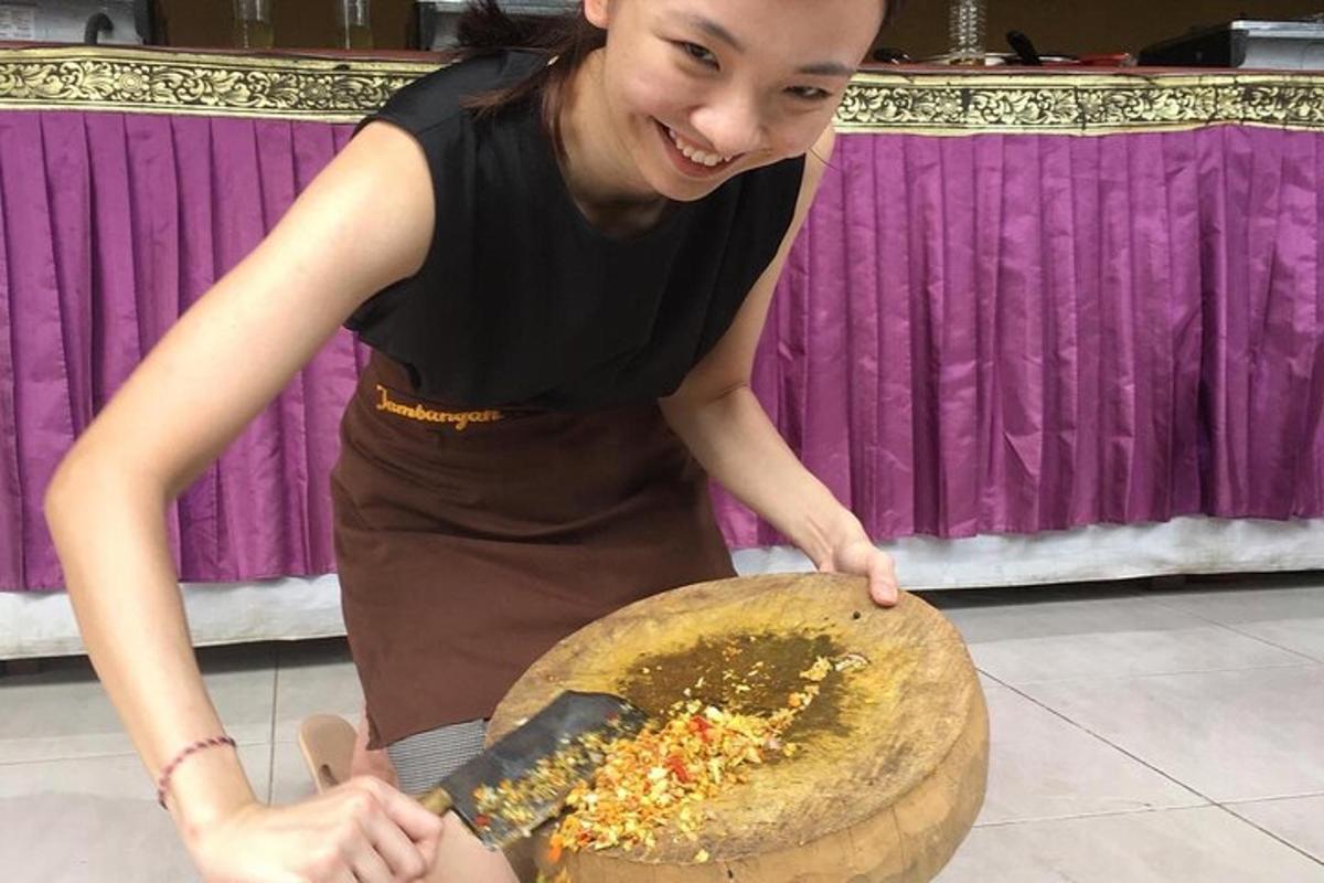 a woman is cutting a pizza with a spatula