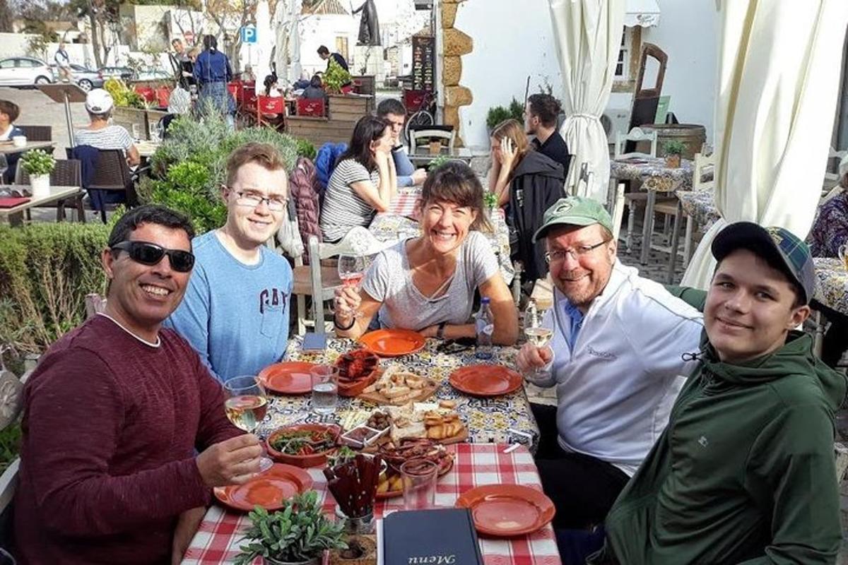 skupina lidí sedících kolem stolu s jídlem