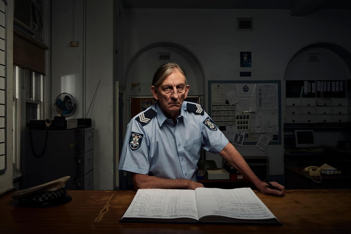 a man sitting at a table with a book
