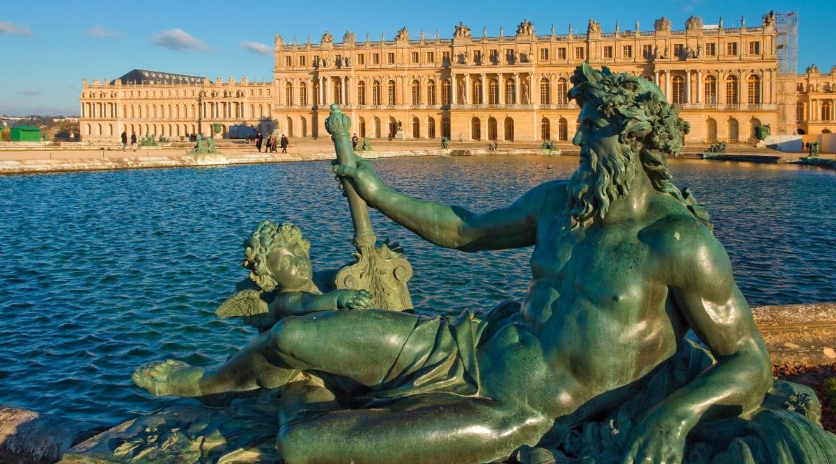 a statue in the water in front of a building
