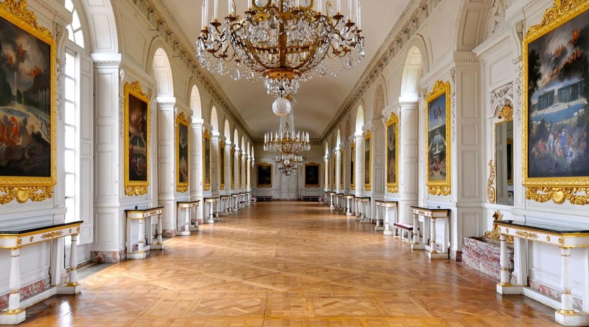 a hallway in the palace of versailles with paintings