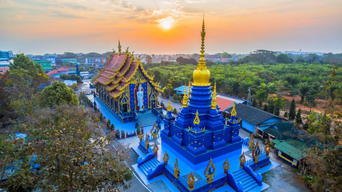 an overhead view of a blue and yellow building with turrets