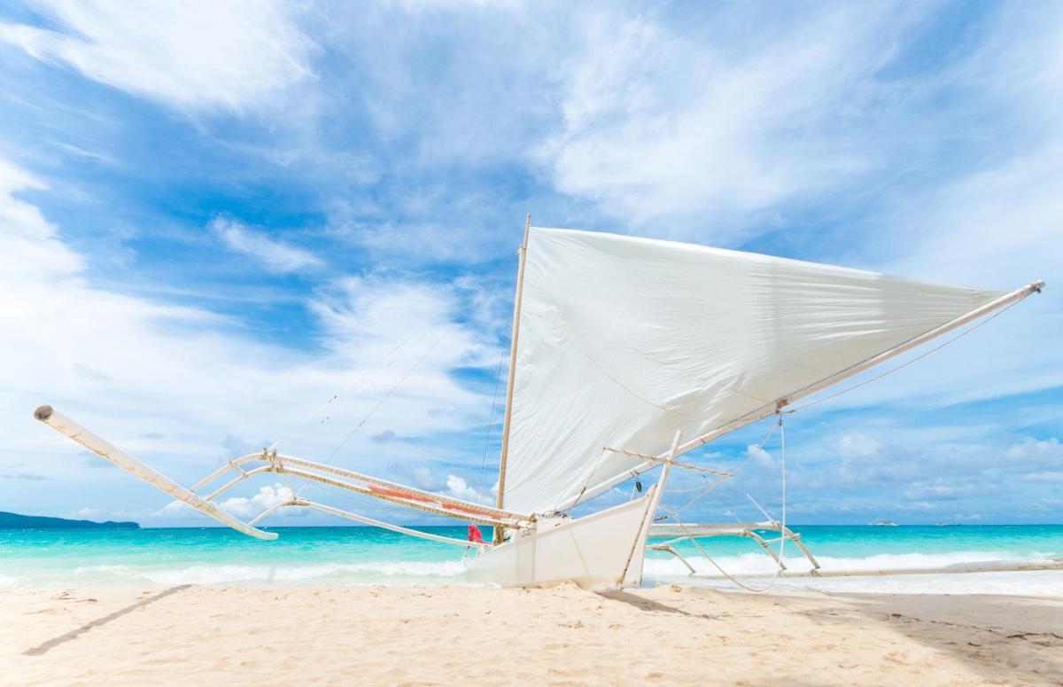 a white chair on a beach with the ocean