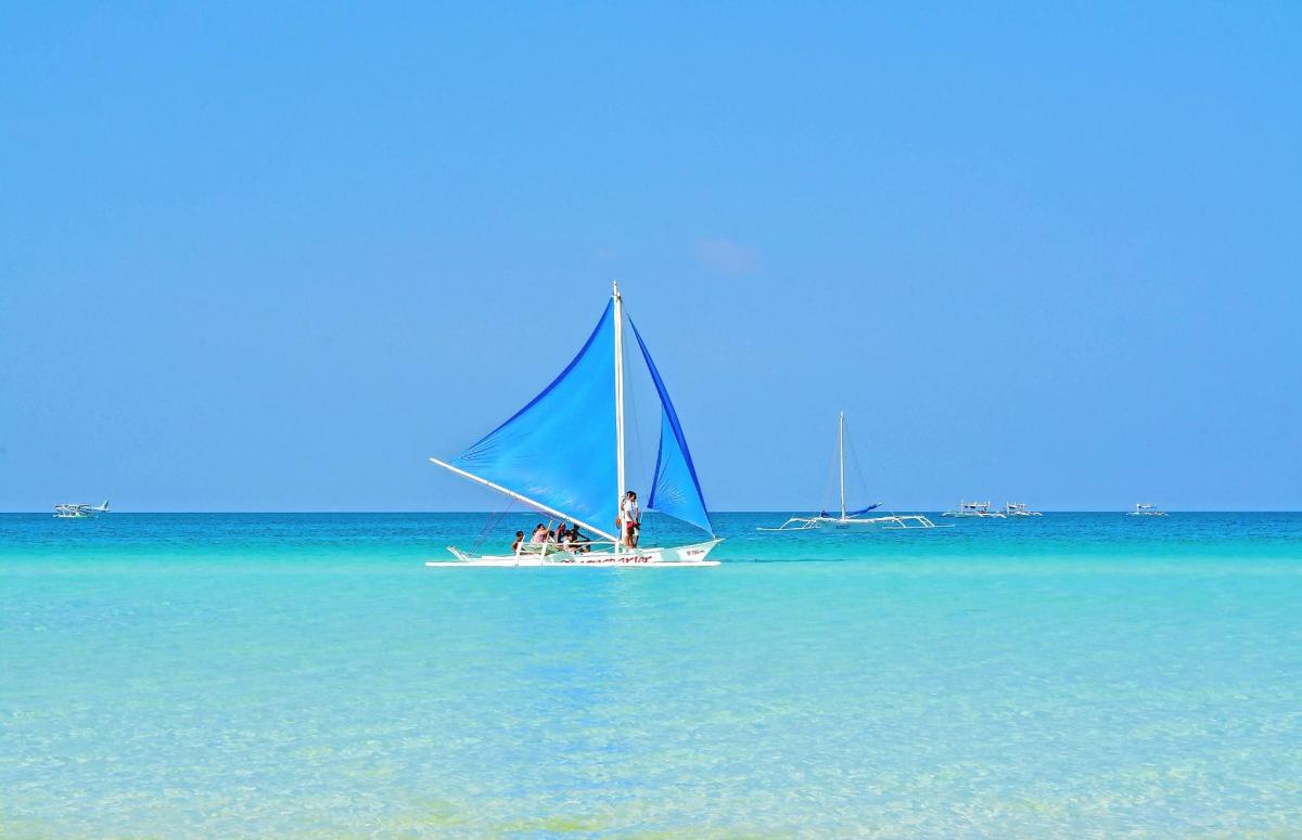 a man on a sail boat in the water
