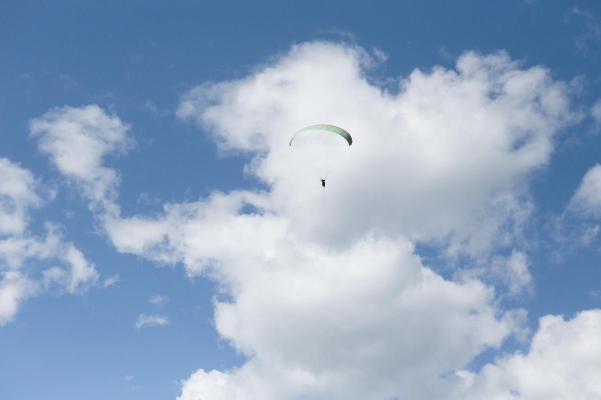 a person is flying a kite in a cloudy sky