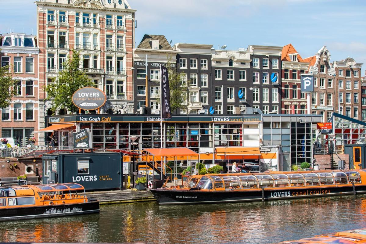 two boats are docked in the water next to buildings