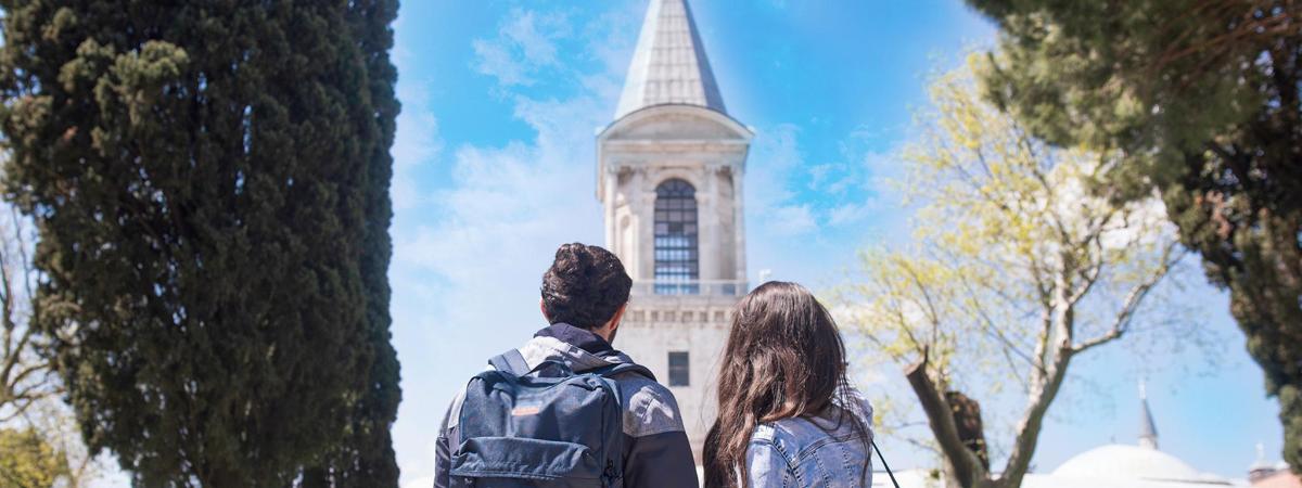 a man and a woman standing in front of a building