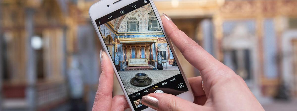 a person taking a picture of a building on a cell phone