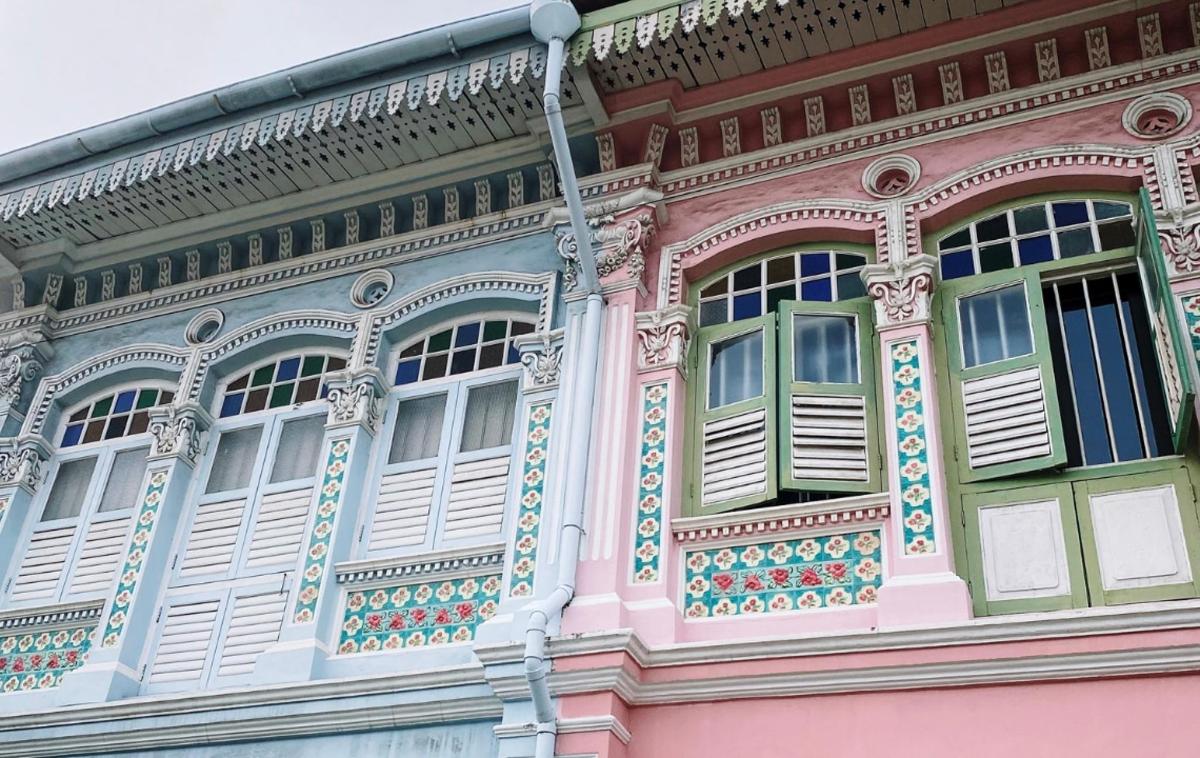 a pink building with windows on the side of it