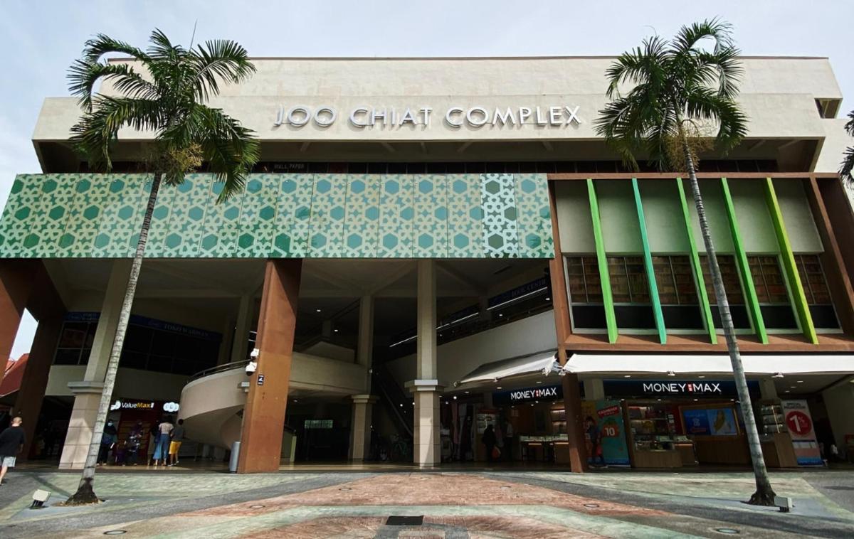 a building with two palm trees in front of it