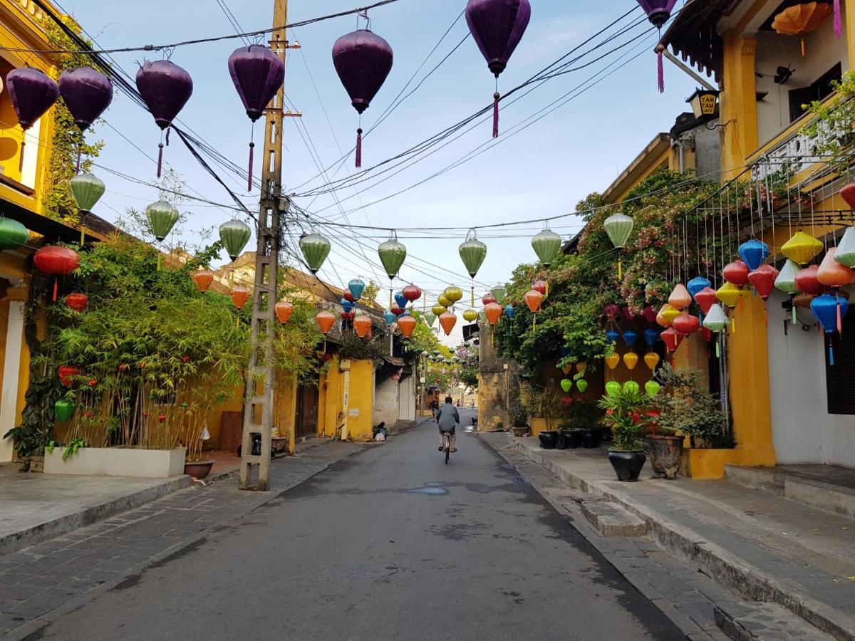 a person walking down a street with colorful lanterns
