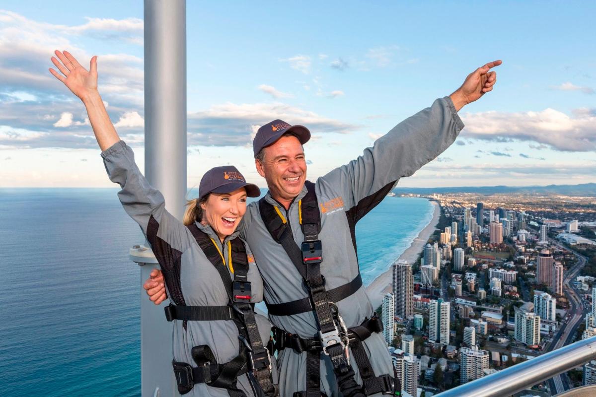 a man and a woman standing on top of a tower
