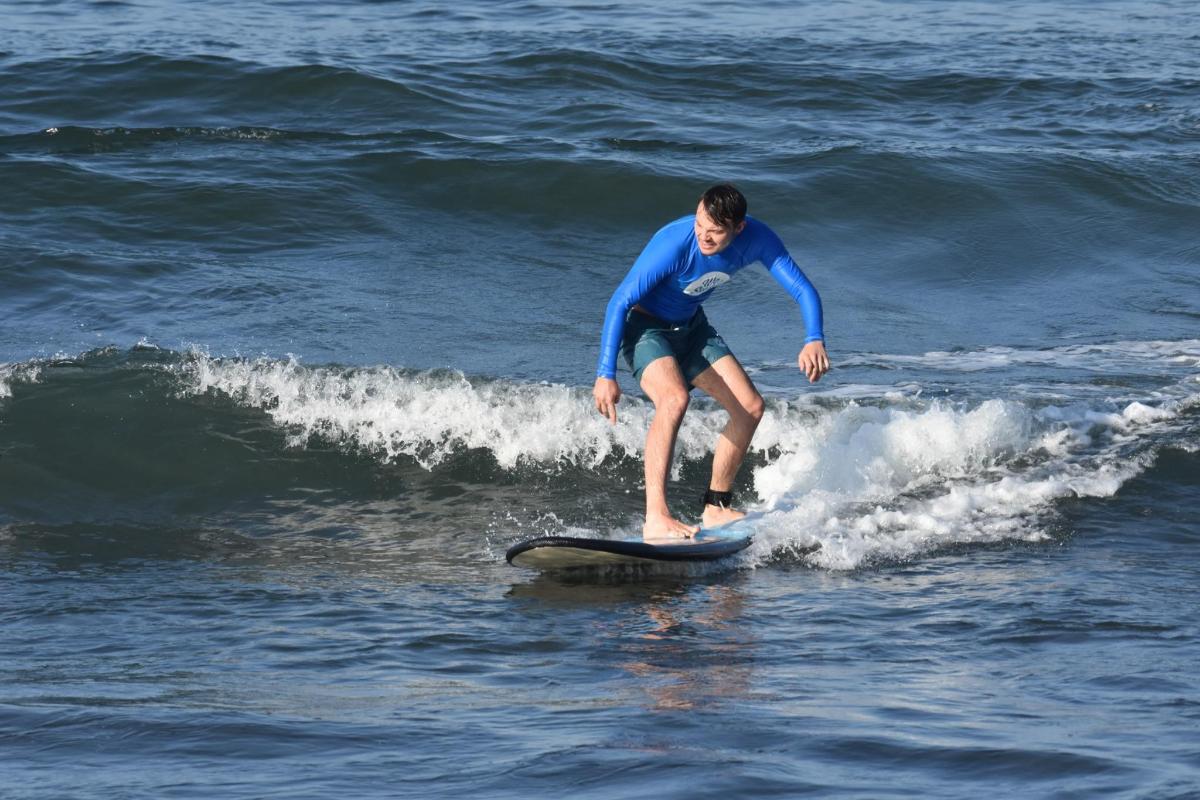 a man riding a wave on a surfboard in the ocean