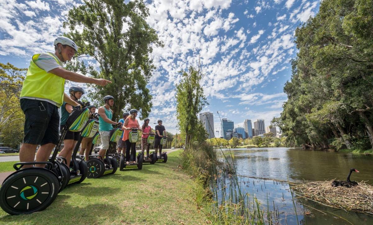 a group of people riding oncycles along a river