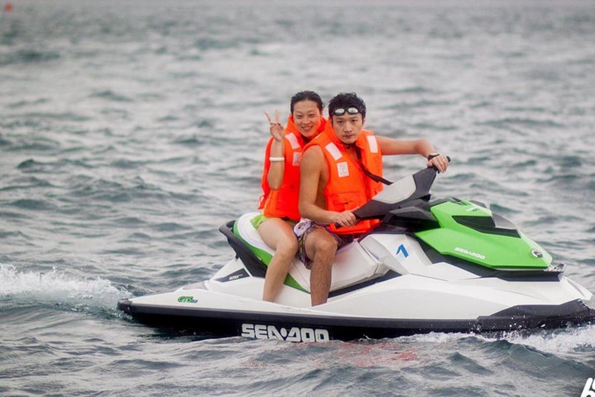 two men in life jackets on a jet ski in the water
