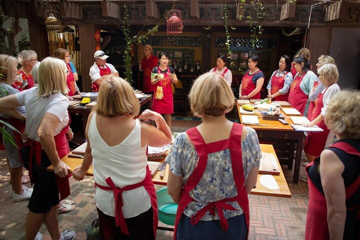 a group of women standing around a table with food