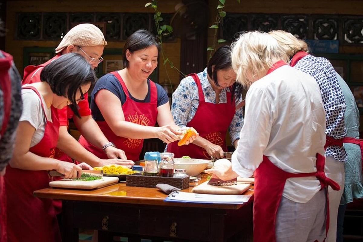 a group of people standing around a table preparing food