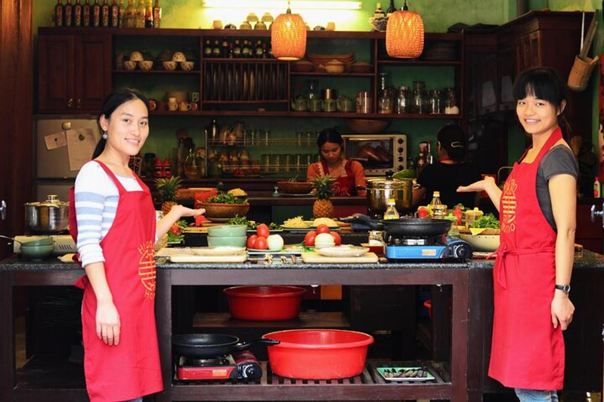 two women standing in a kitchen preparing food