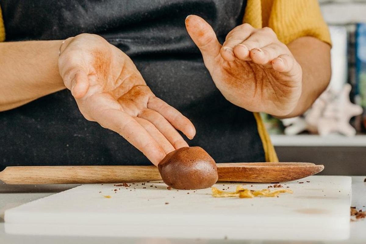 a person holding a thumb up next to a piece of food