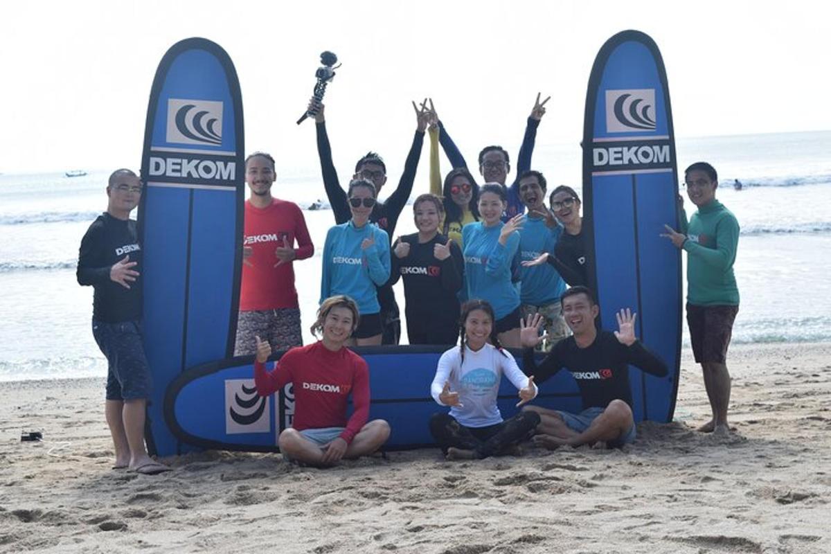 a group of people standing on the beach with surfboards