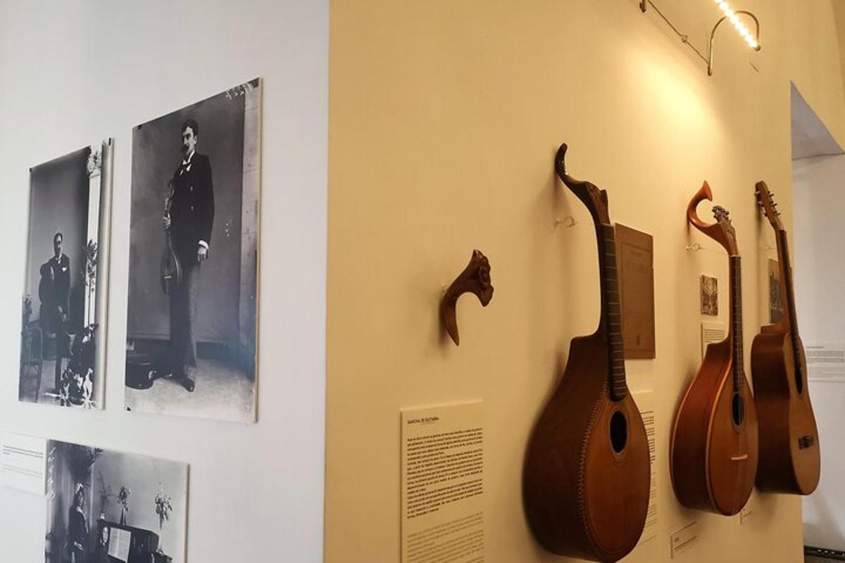 a guitar hanging on a wall next to a picture