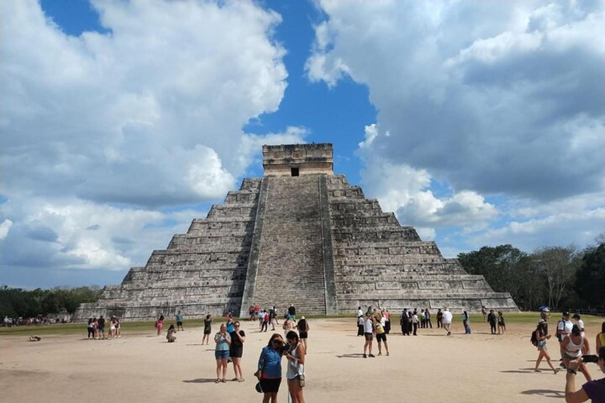 skupina lidí stojící před pyramidou
