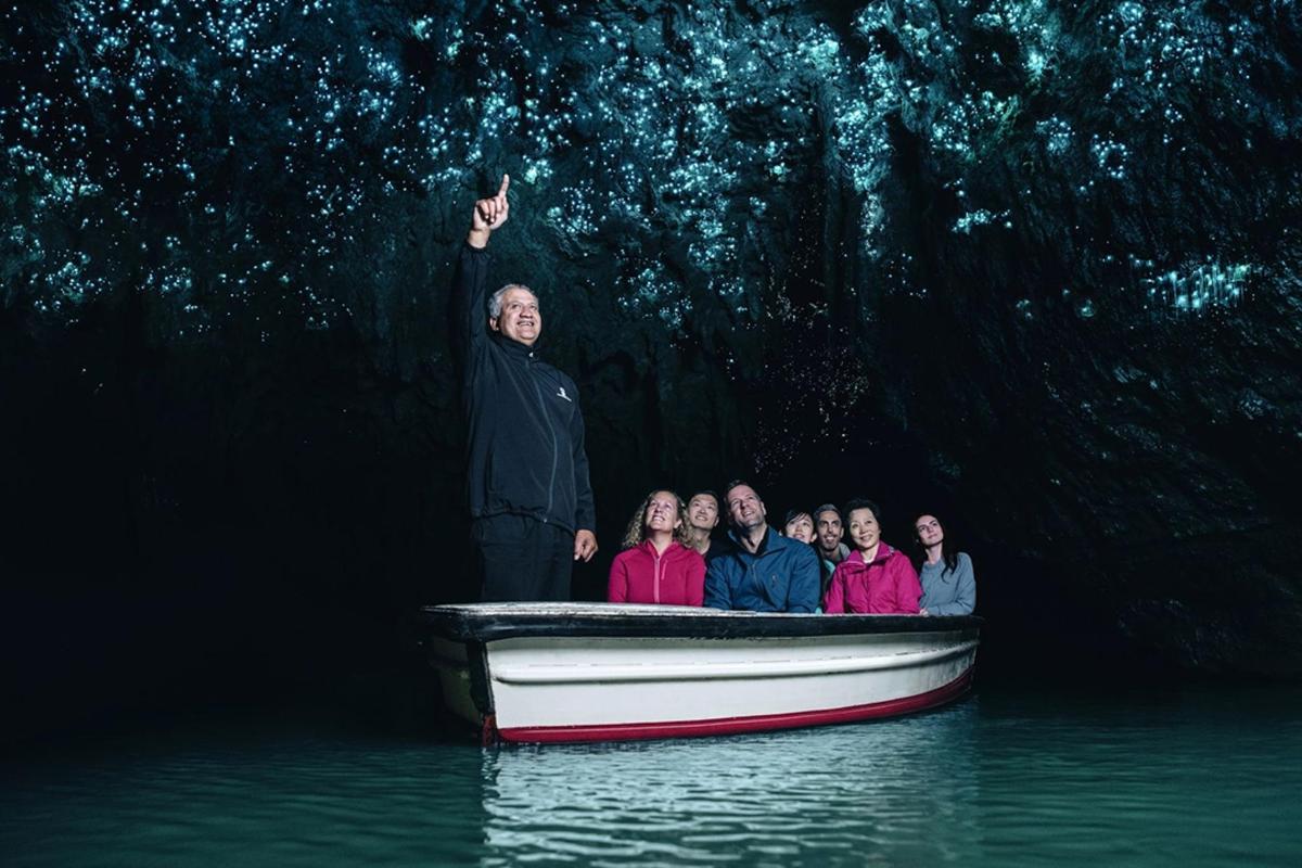 a man standing in a boat with a group of people