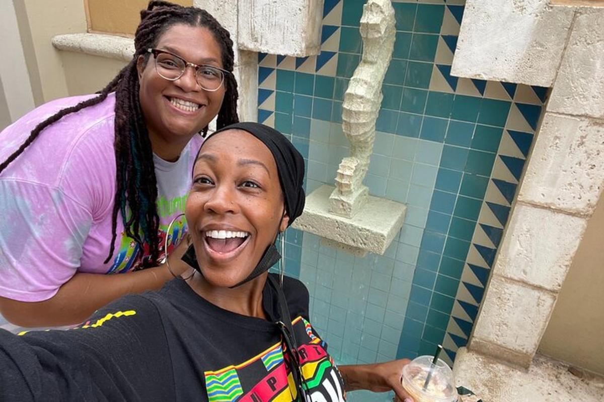 two women posing for a picture in a bathroom