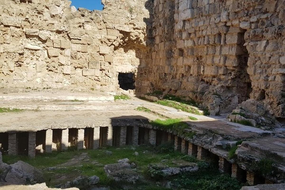 an ancient ruins with a pool of water in a building