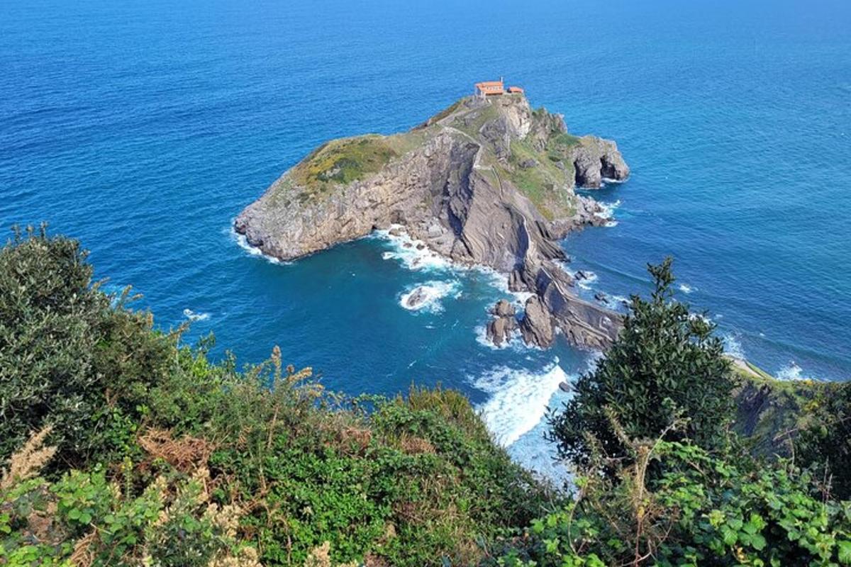 an island in the ocean with a house on it