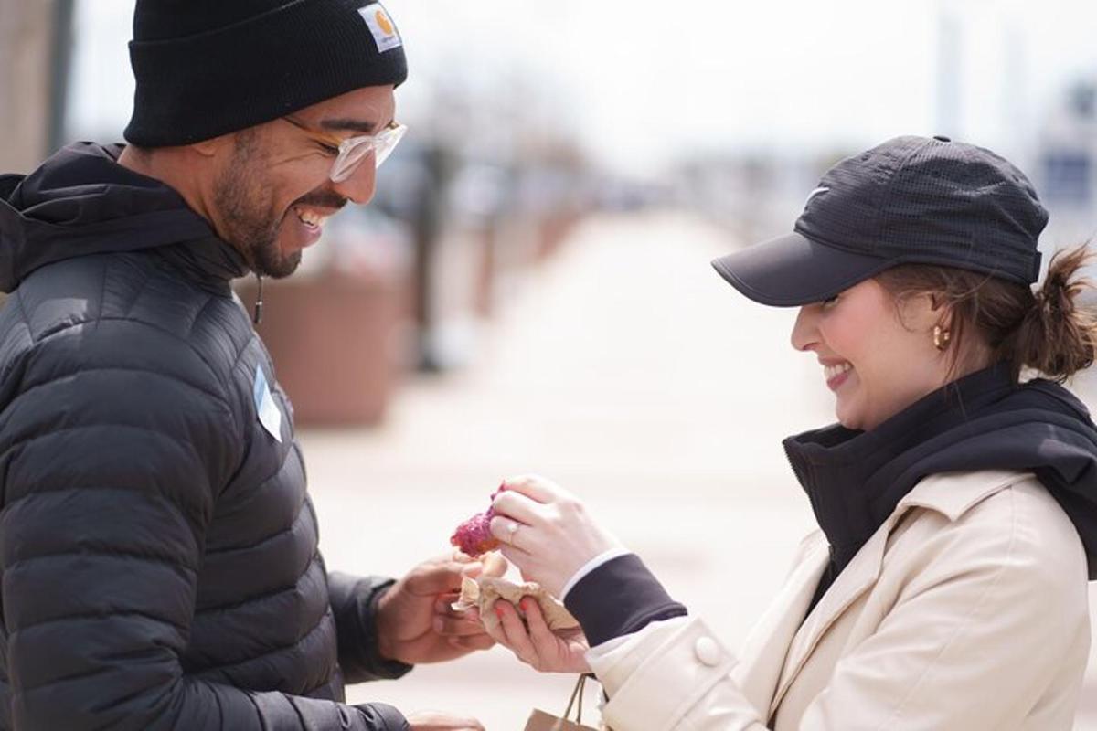 a man and a woman eating a sandwich