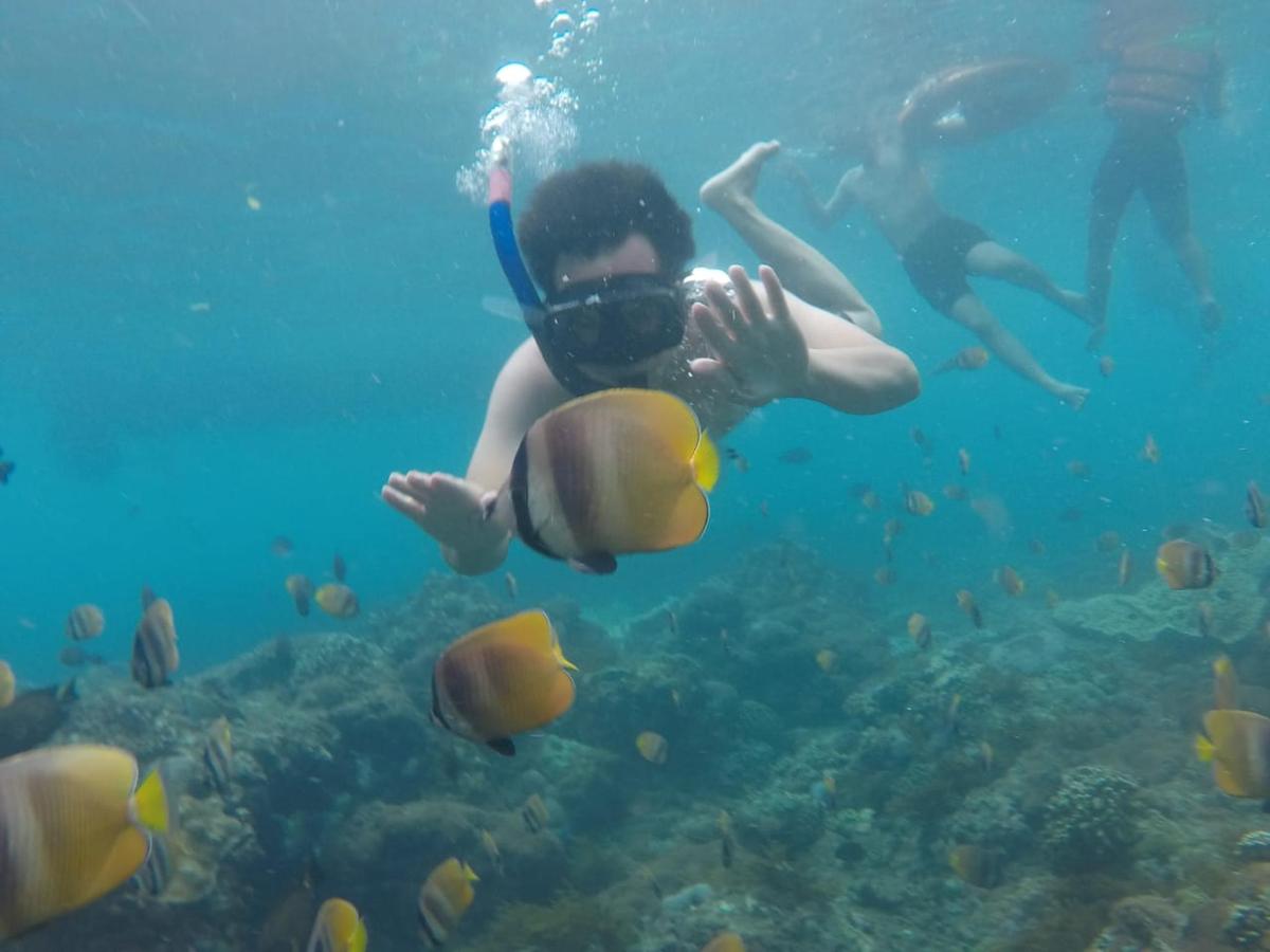 a person swimming in the water with a camera