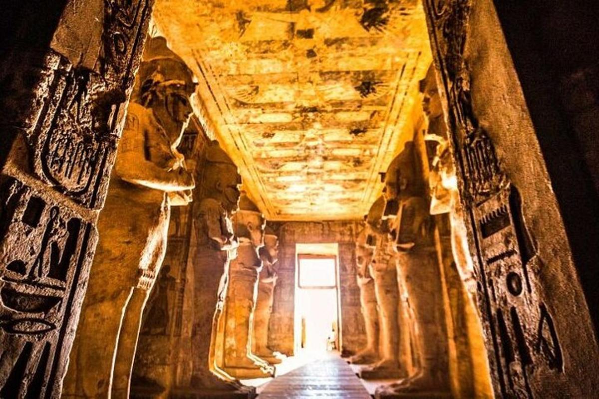 a hallway in a cave with columns and a ceiling