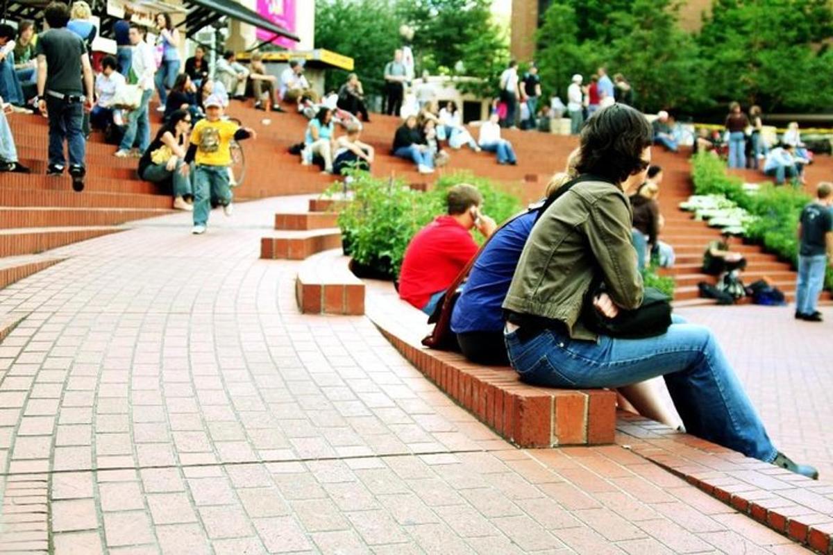 a group of people sitting on benches in a park