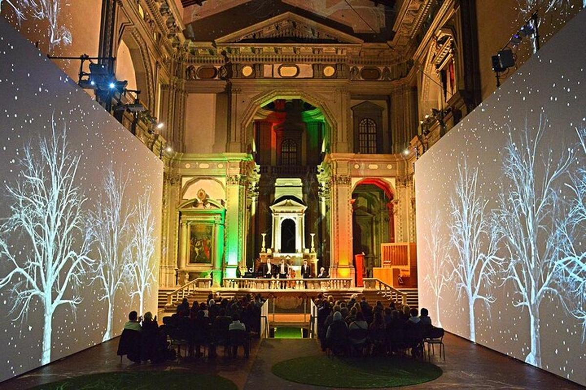 a large room with people sitting in a building with lights