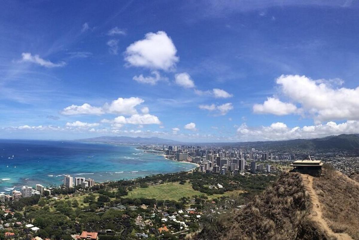 a view of a city and the ocean from a mountain