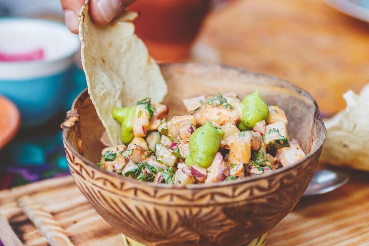 a person is holding a bowl of food