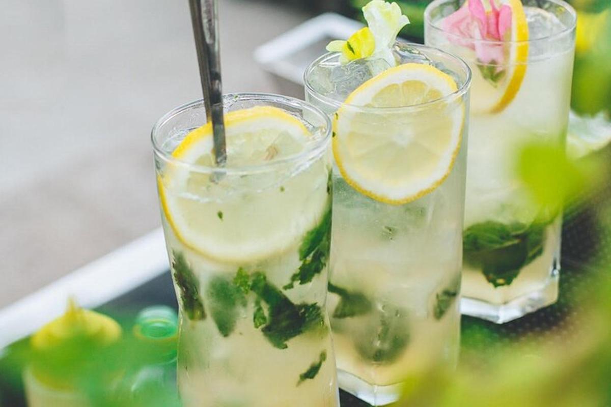 a group of four glasses of lemonade on a tray