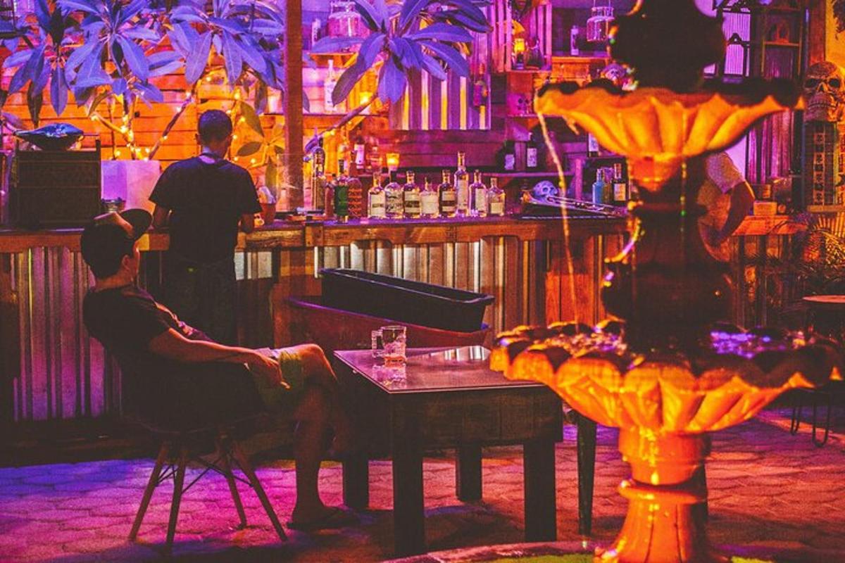 a bar with a man sitting at a table in a bar