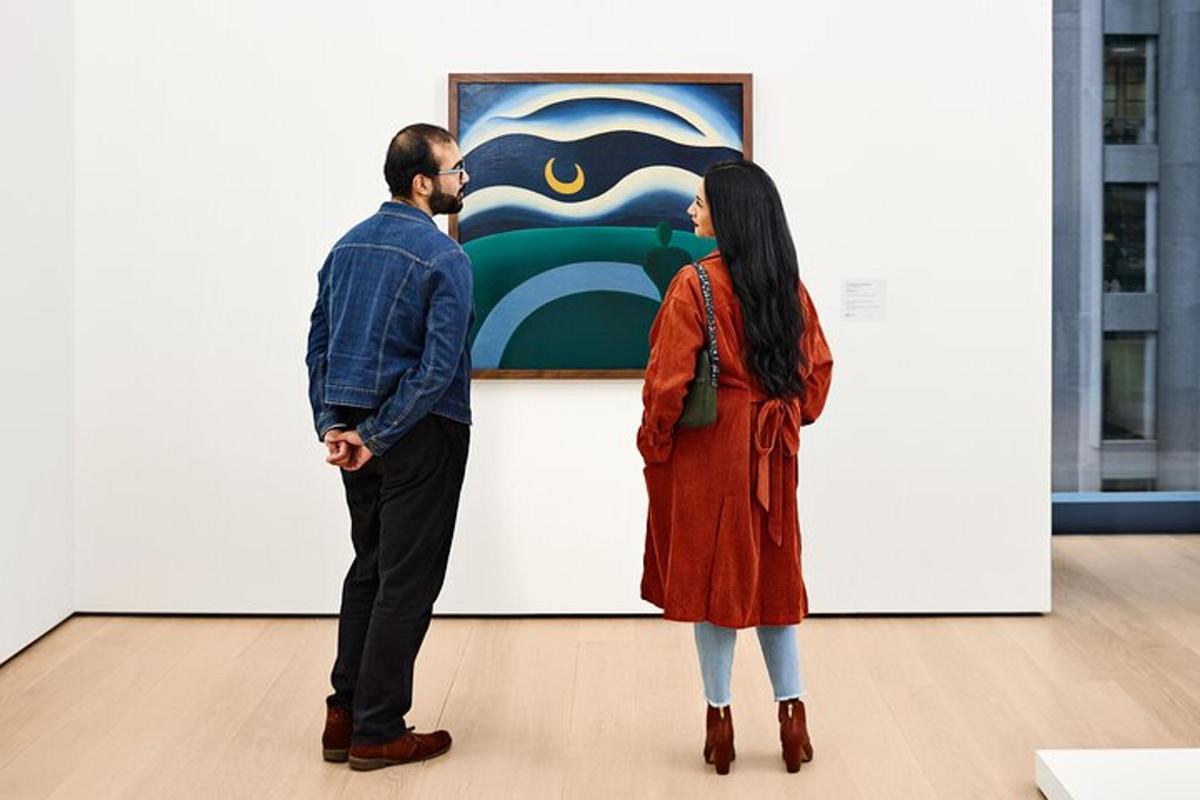 a man and a woman looking at a painting in an art museum