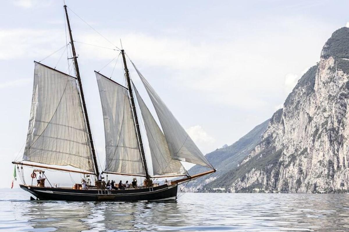 a group of people on a sail boat in the water
