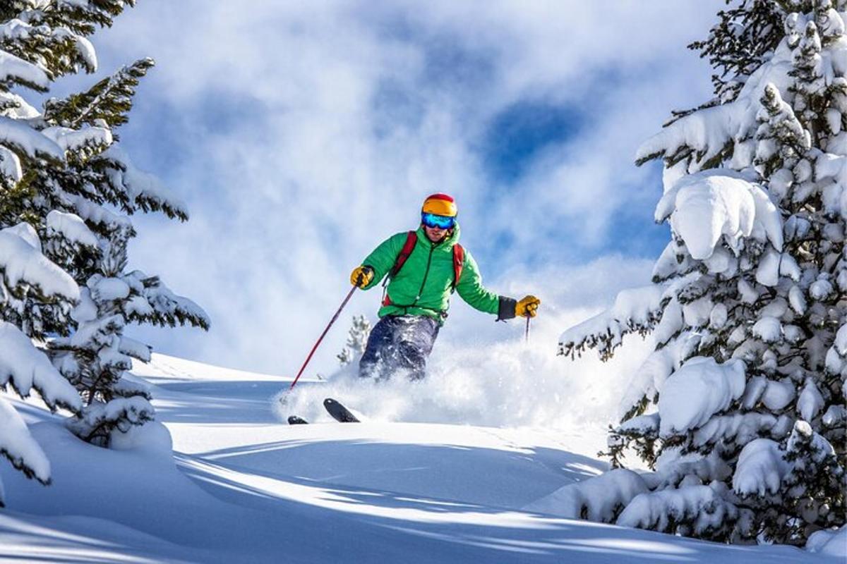 a man is skiing down a snow covered slope