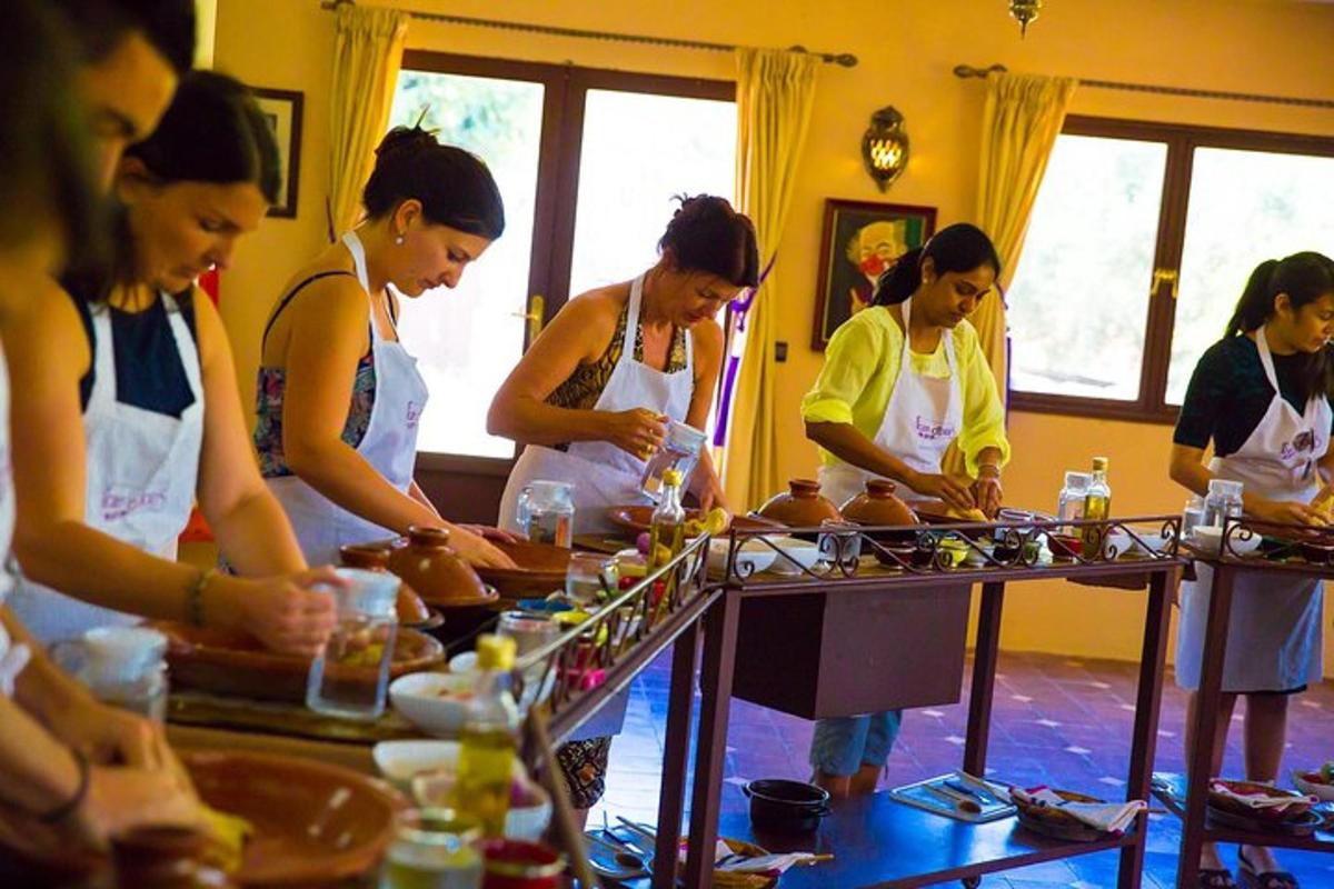 a group of women in a kitchen preparing food